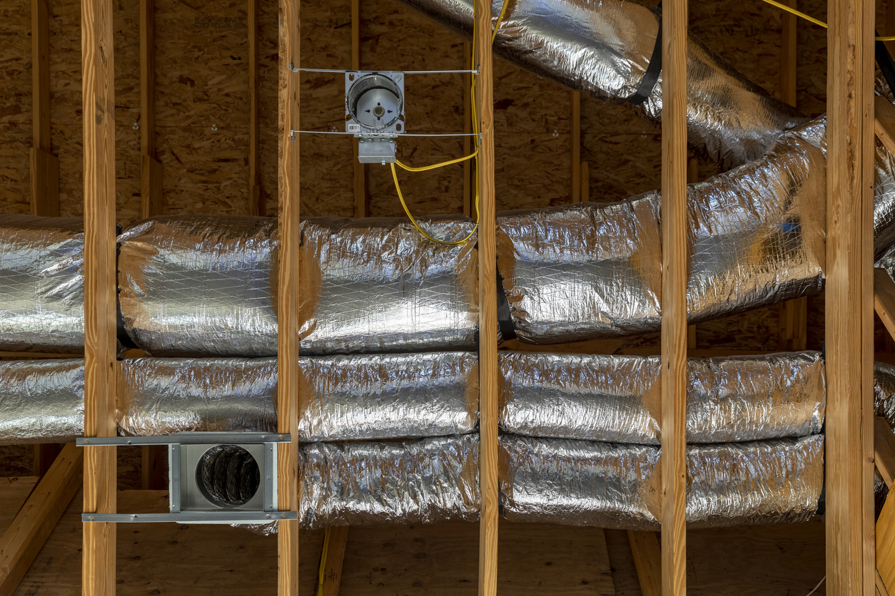 Newly installed ductwork in a home's open ceiling