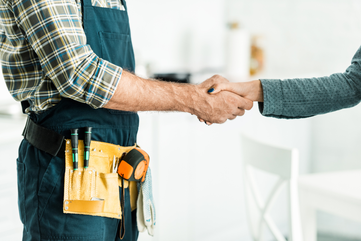 Technician shaking a homeowner's hand after services
