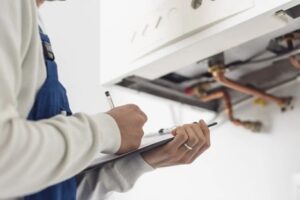 Technician adjusting HVAC equipment.