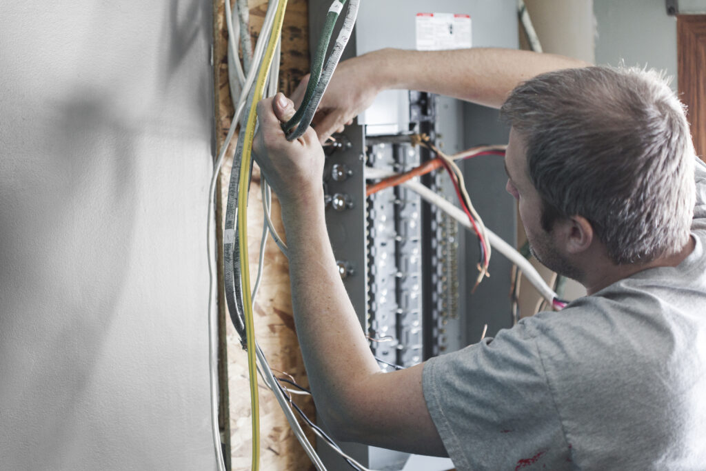 Electrician upgrading breaker panel in home